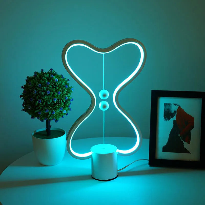 LED balance night lamp with 7 colour options, USB powered, showing suspended netball design
