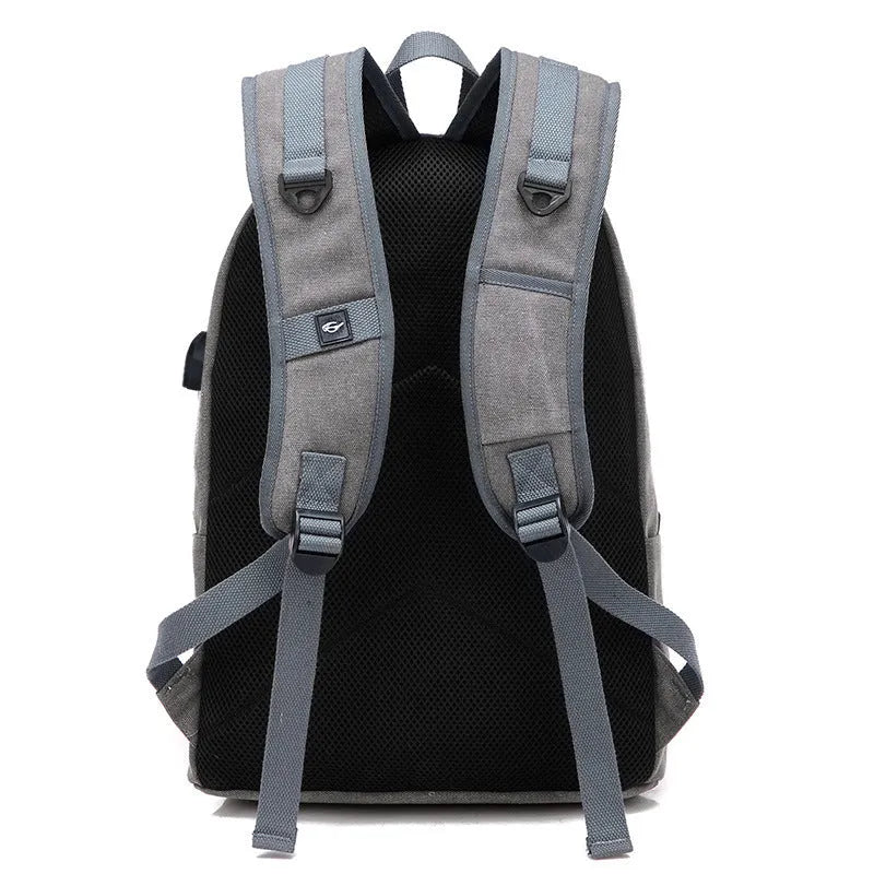 Coffee-coloured canvas backpack with USB charging port and multiple compartments.