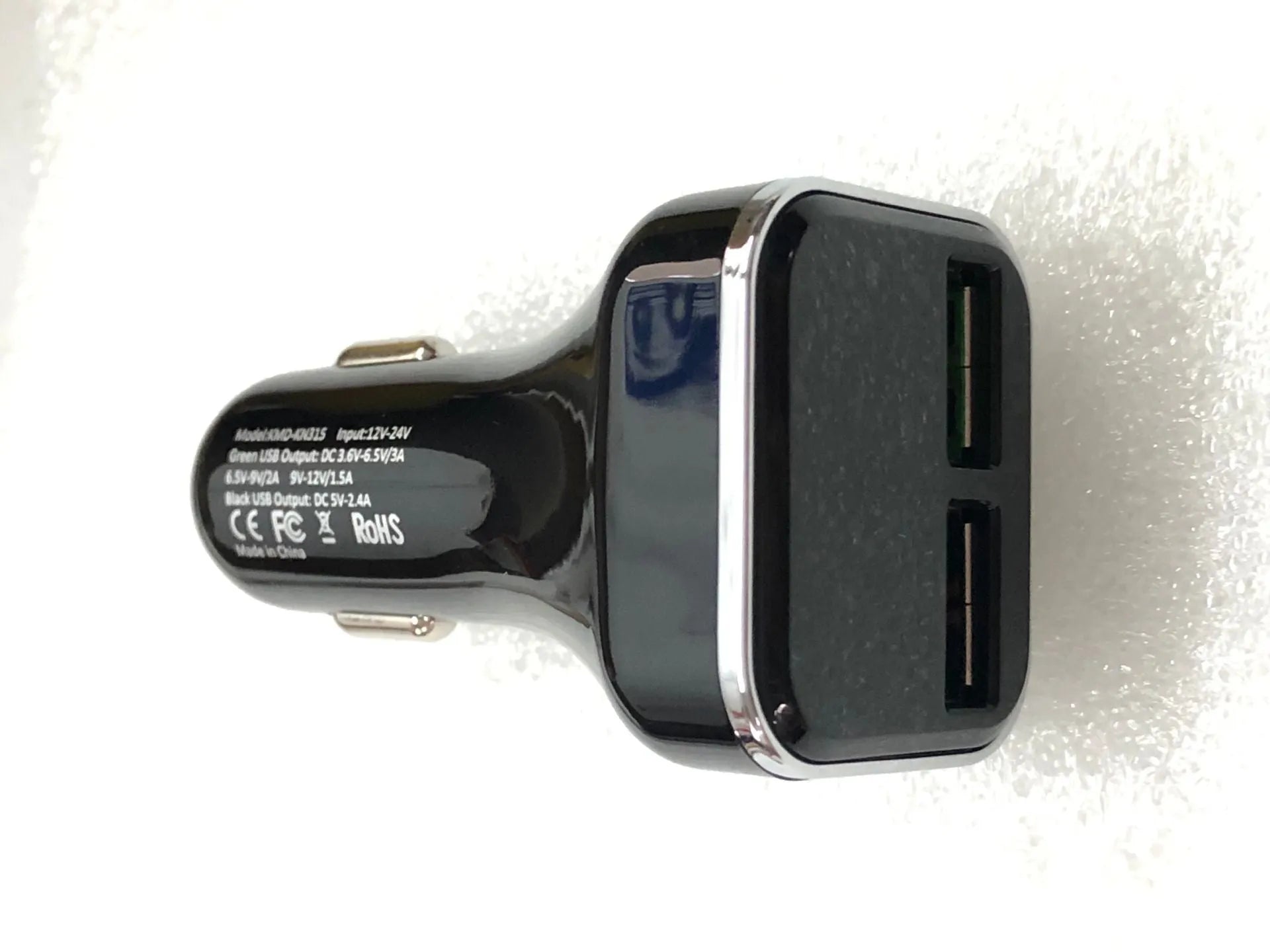 Black car charger with digital display showing voltage and current readings, dual USB ports