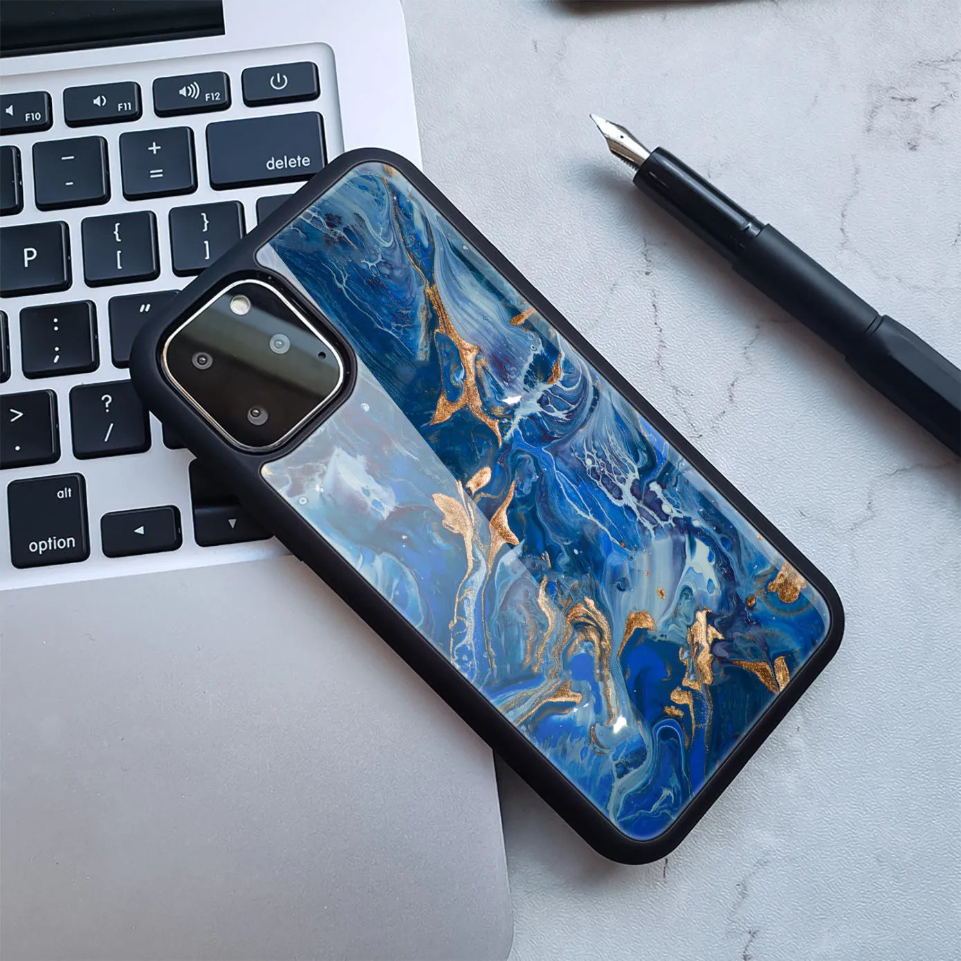 Marble pattern plastic iPhone case in black and gold colour combination showing back cover design