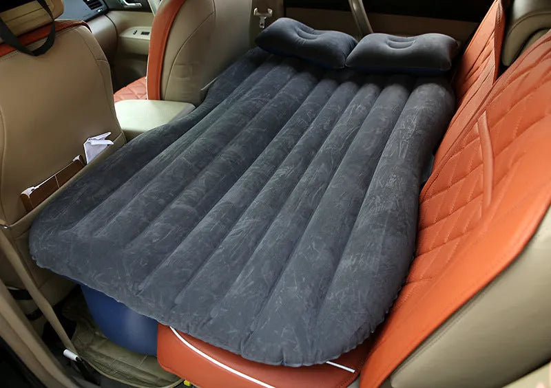 Universal inflatable car bed with flocked cloth, shown with two pillows and a pump.