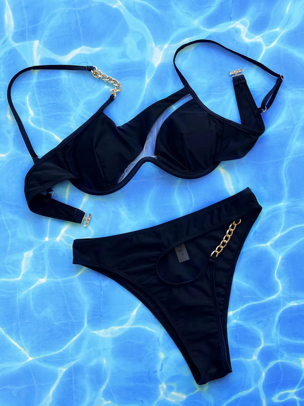 Women's black two-piece swimsuit with hollow split design and high-cut leg