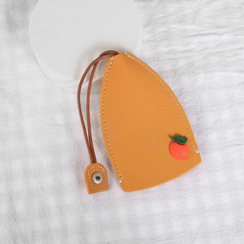 Cartoon pull-out key case in PU leather measuring 14 x 7.5 cm with colourful designs
