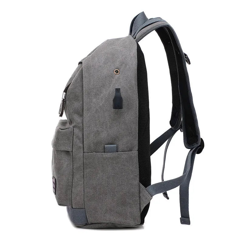 Coffee-coloured canvas backpack with USB charging port and multiple compartments.