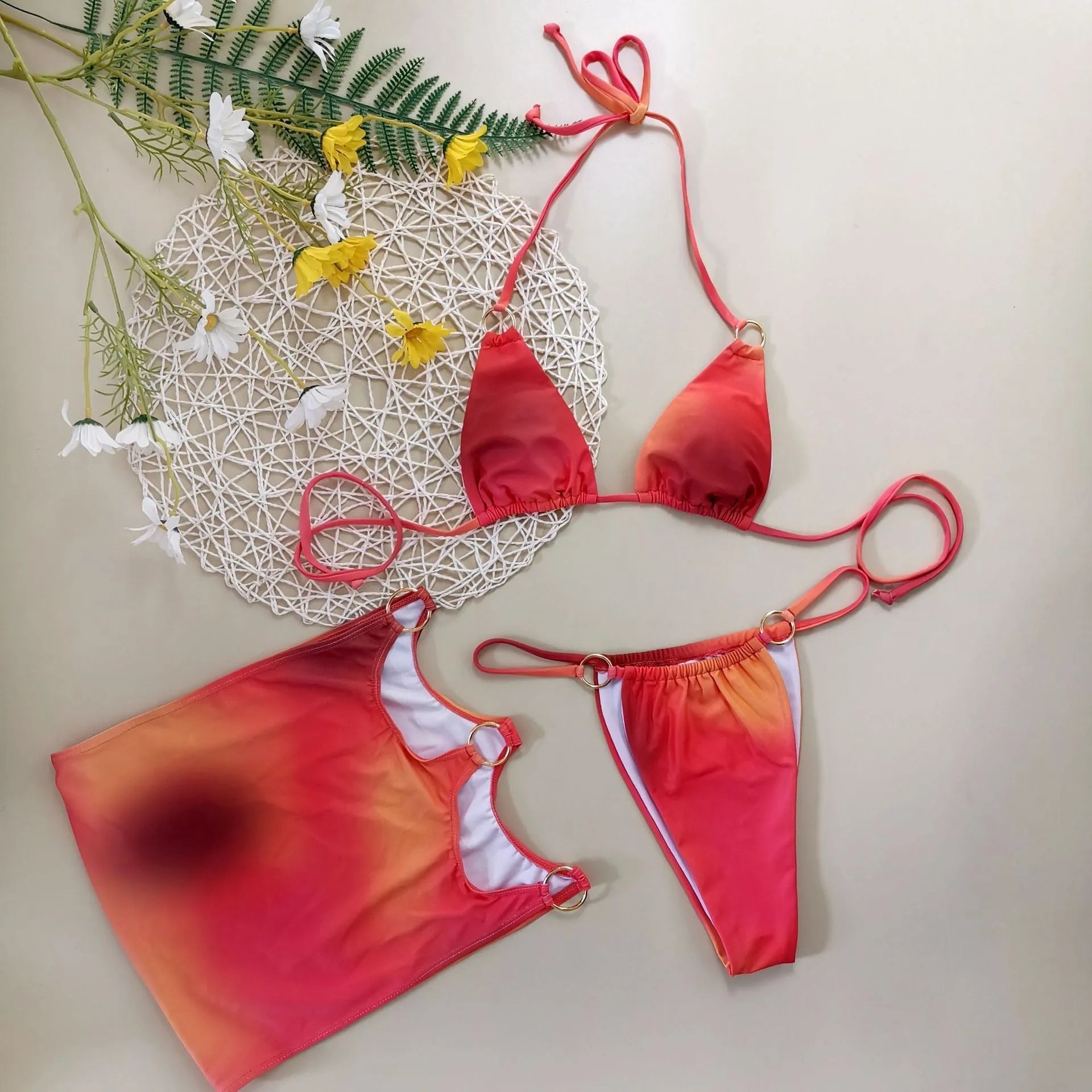 Tie-dye gradient pattern halter bikini three-piece swimsuit set on a hanger