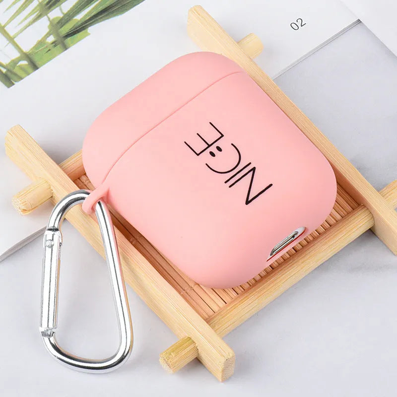 Black and pink polycarbonate AirPods case covers with decorative flower and smiley face back designs.