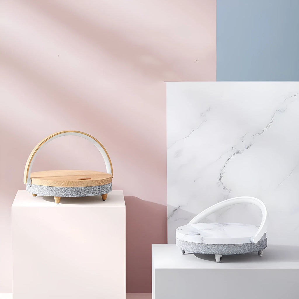 Wireless charging LED night lamp with Bluetooth speaker in marble pattern finish showing phone on charging surface