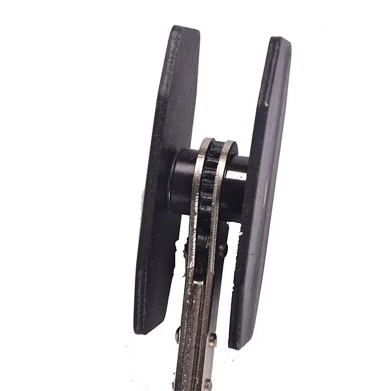 Black stainless steel brake caliper press with ratchet mechanism on bench
