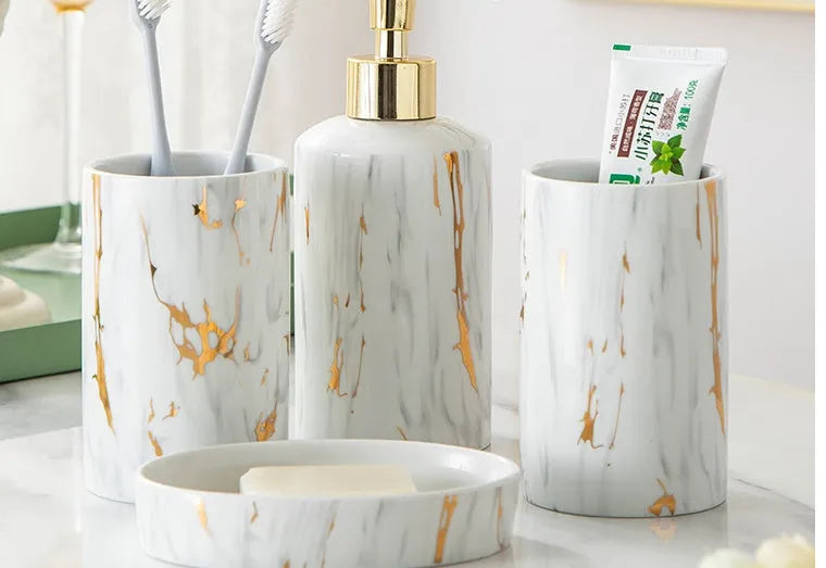 White ceramic bathroom wash kit set with two cups, a soap dish, and a bottle in a presentation box.