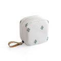 A blue cube-shaped cloth makeup storage bag sitting on a surface, open to show interior space.
