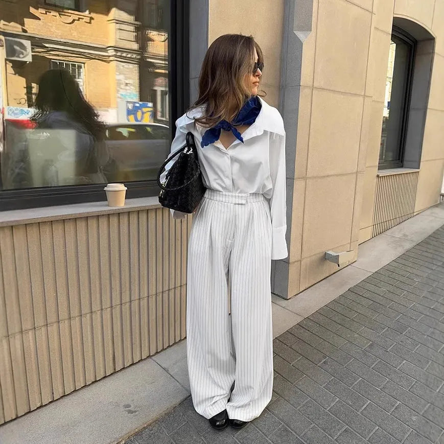 White striped wide-leg casual trousers with a loose fit and zipper detail on a mannequin.