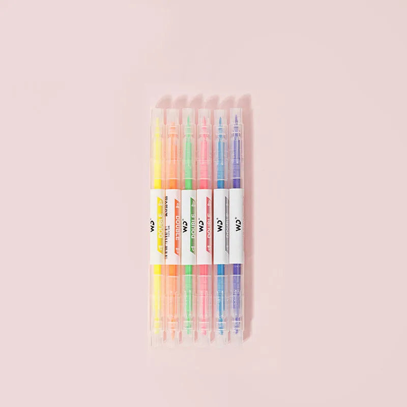 Six double-headed marker pens showing round and oblique nibs in assorted colours including orange, purple, yellow, green, blue, and pink