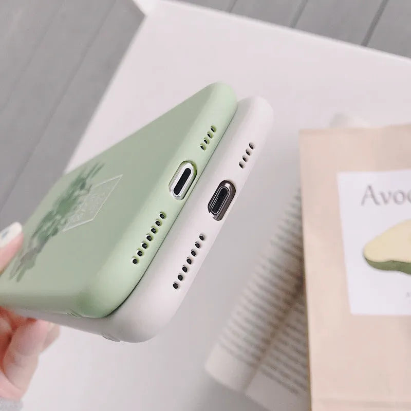 White silicone iPhone case with a detailed green plant pattern on the back, showing full device coverage.