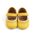 Baby girl's white velcro fastening shoes with low tube height, shown on a size chart.