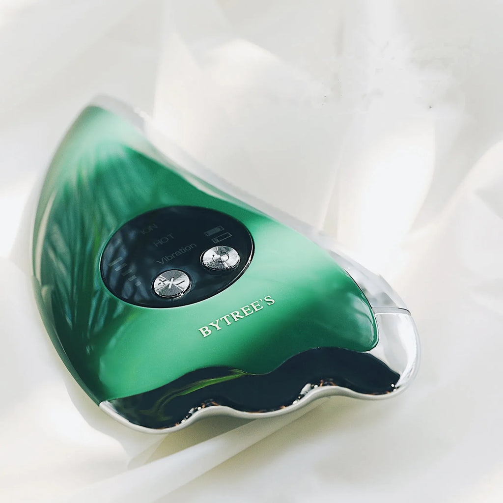 Green facial beauty instrument with plastic and metal body and USB cable