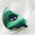 Green facial beauty instrument with plastic and metal body and USB cable