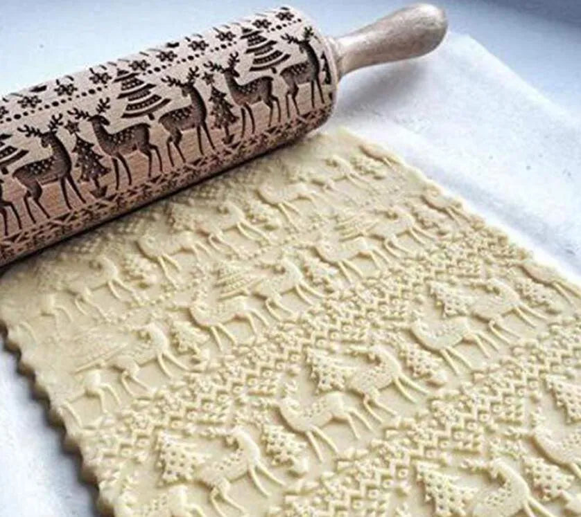 Wooden rolling pin with embossed Christmas patterns including reindeer and snowflakes on a 45cm length.