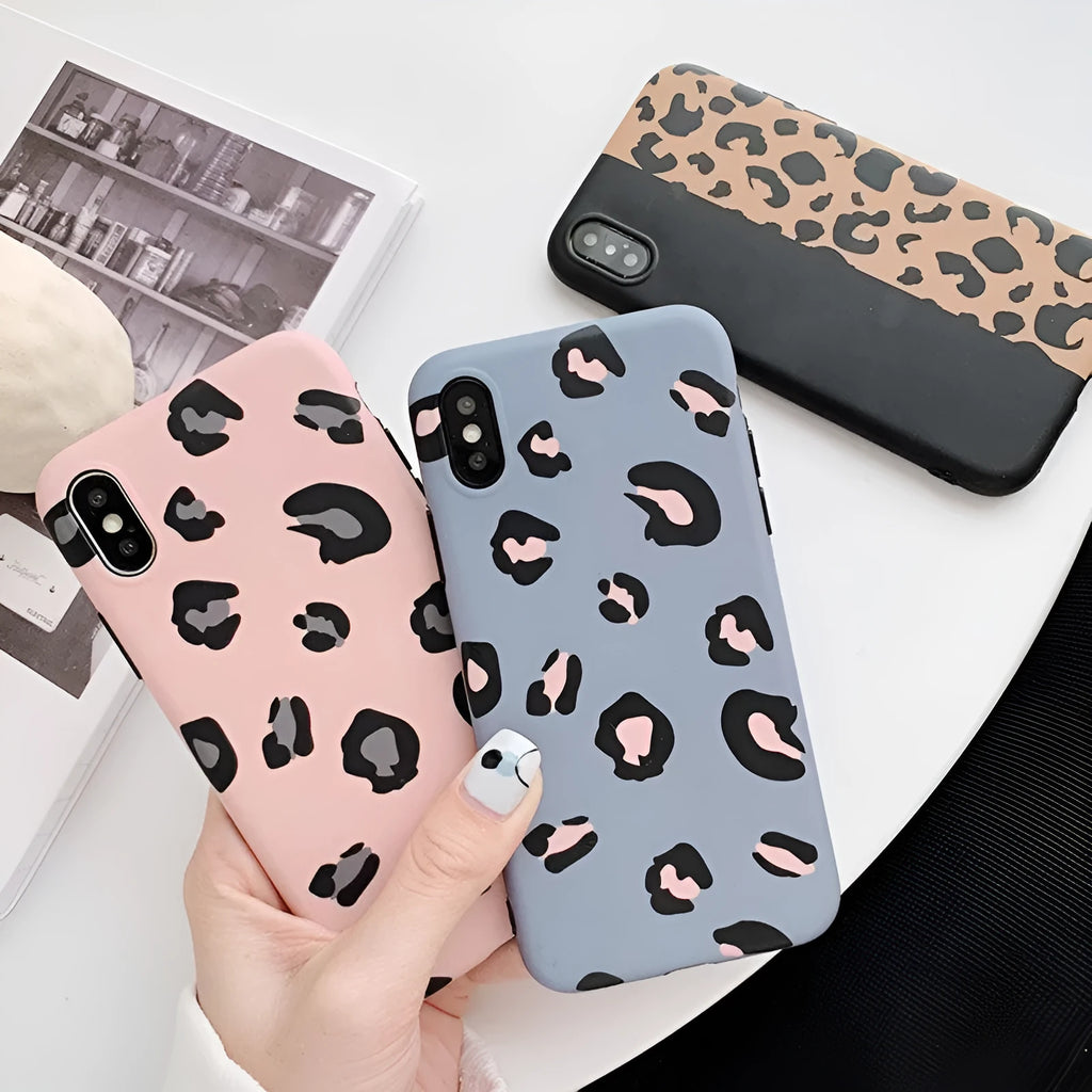 Leopard print pattern phone case for iPhone models on a table.