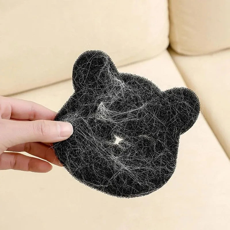 Two black bear-shaped sponge cleaning balls for pet hair removal in laundry