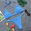 Women's solid colour thong bikini set in black nylon with adjustable straps and chest pad