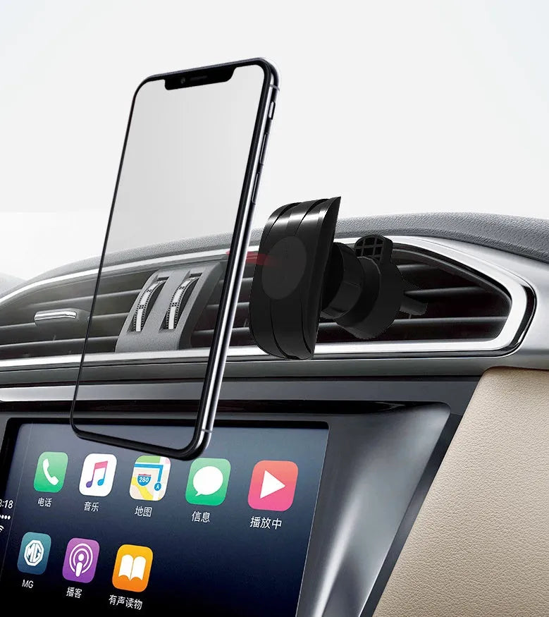 Black car phone holder clipped to vehicle air vent holding smartphone for navigation