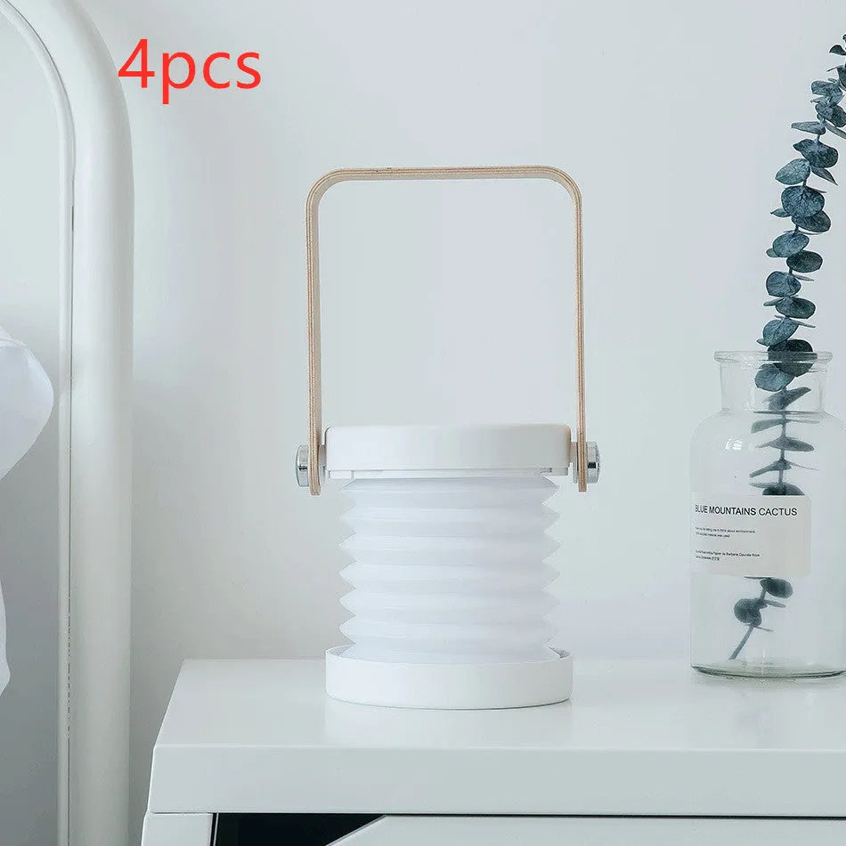 Foldable touch dimmable LED night light in white, shown in both table lamp and unfolded lantern modes.