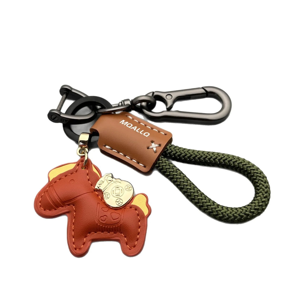 Handmade brown cowhide key ring pendant with a zinc alloy pony buckle on a green flanelle rope.