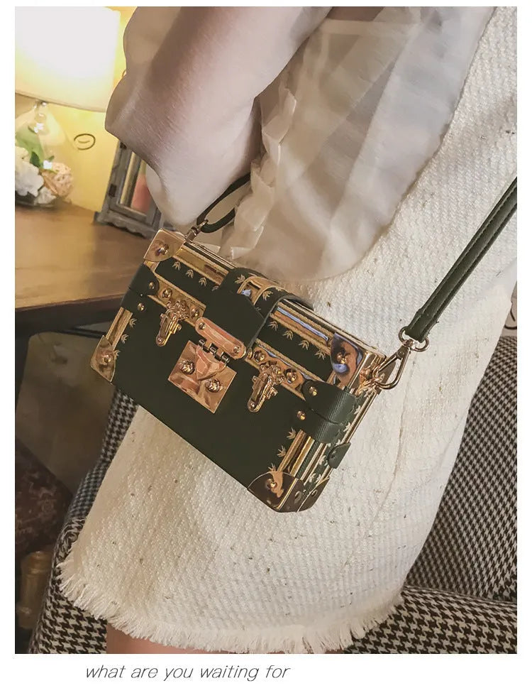 Black hard shell women's shoulder bag with a flap and crossbody strap