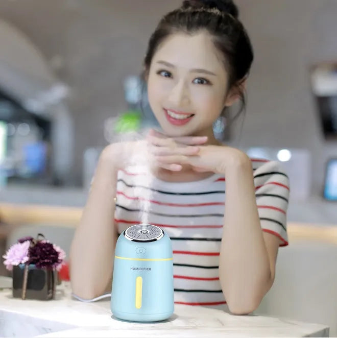 Mini ultrasonic USB humidifier 330ml in blue on desk with fan and LED light