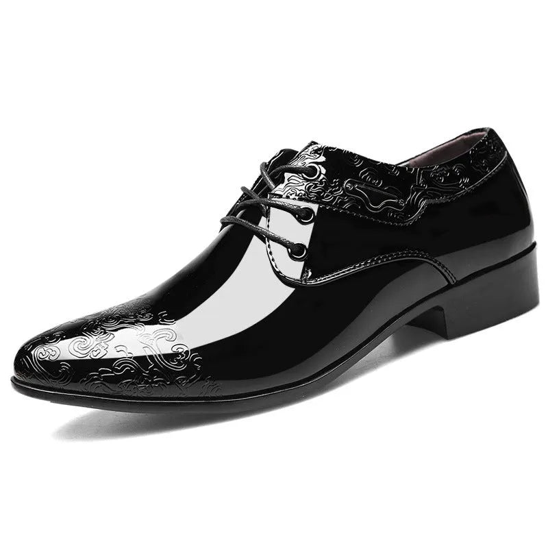 Glossy black men's business formal shoes with patent finish, pointed toe, and carved detail on a neutral background