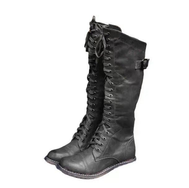 Women's black chunky heel high-leg boots with a round toe and low rubber sole.