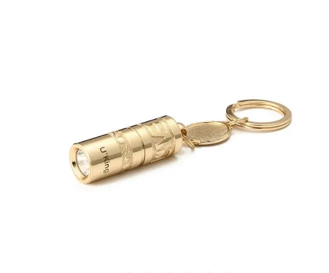 Gold-coloured zinc alloy mini portable LED flashlight on a keyring.