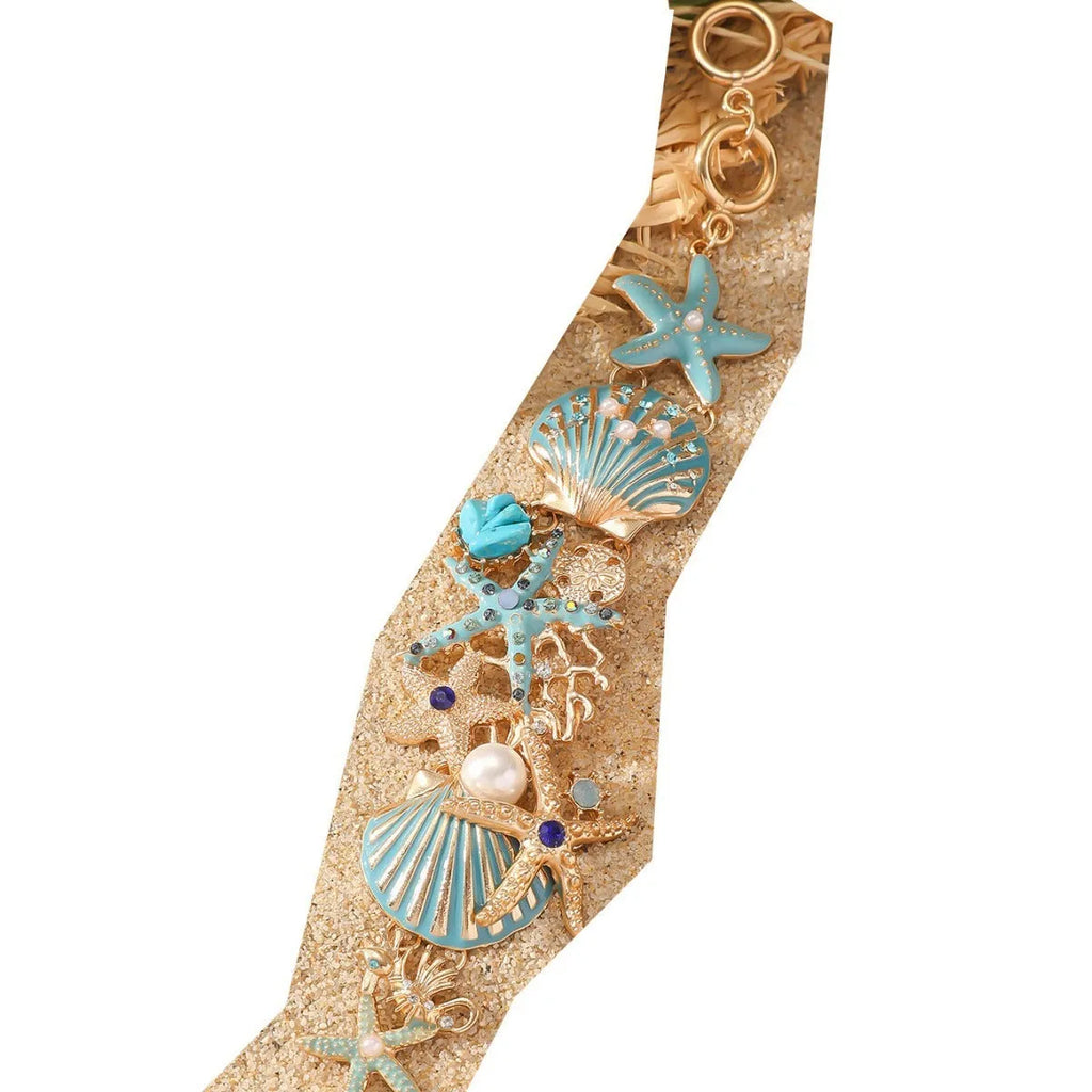 Alloy rhinestone bracelet with boat anchor, marine shell, and starfish charms in blue, red, or turquoise.