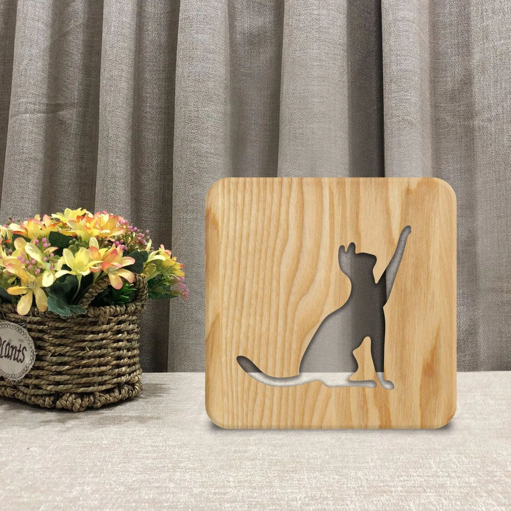 Solid wood pastoral style night light with 3D hollow cat silhouette design.