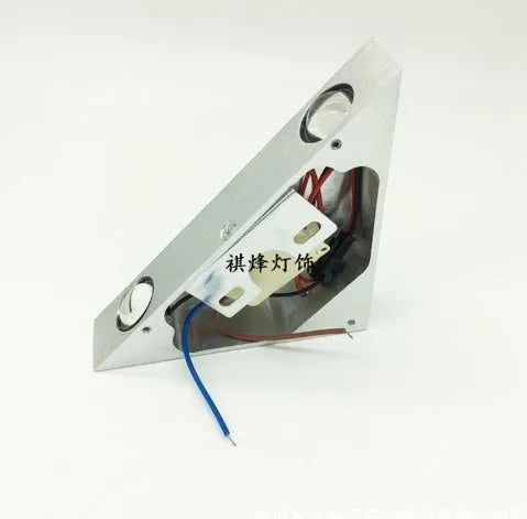 Set of three white LED wall lights with dual heads mounted on a wall showing warm white light