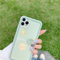 Green TPU iPhone case showing geometric smiley face design with polka dot frame on back