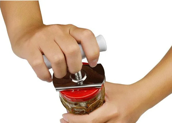 White adjustable stainless steel bottle cap opener with gear mechanism and textured handle.