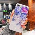 Dream Shell soft TPU iPhone case with rose flower pattern on back, shown in brown, purple and white.