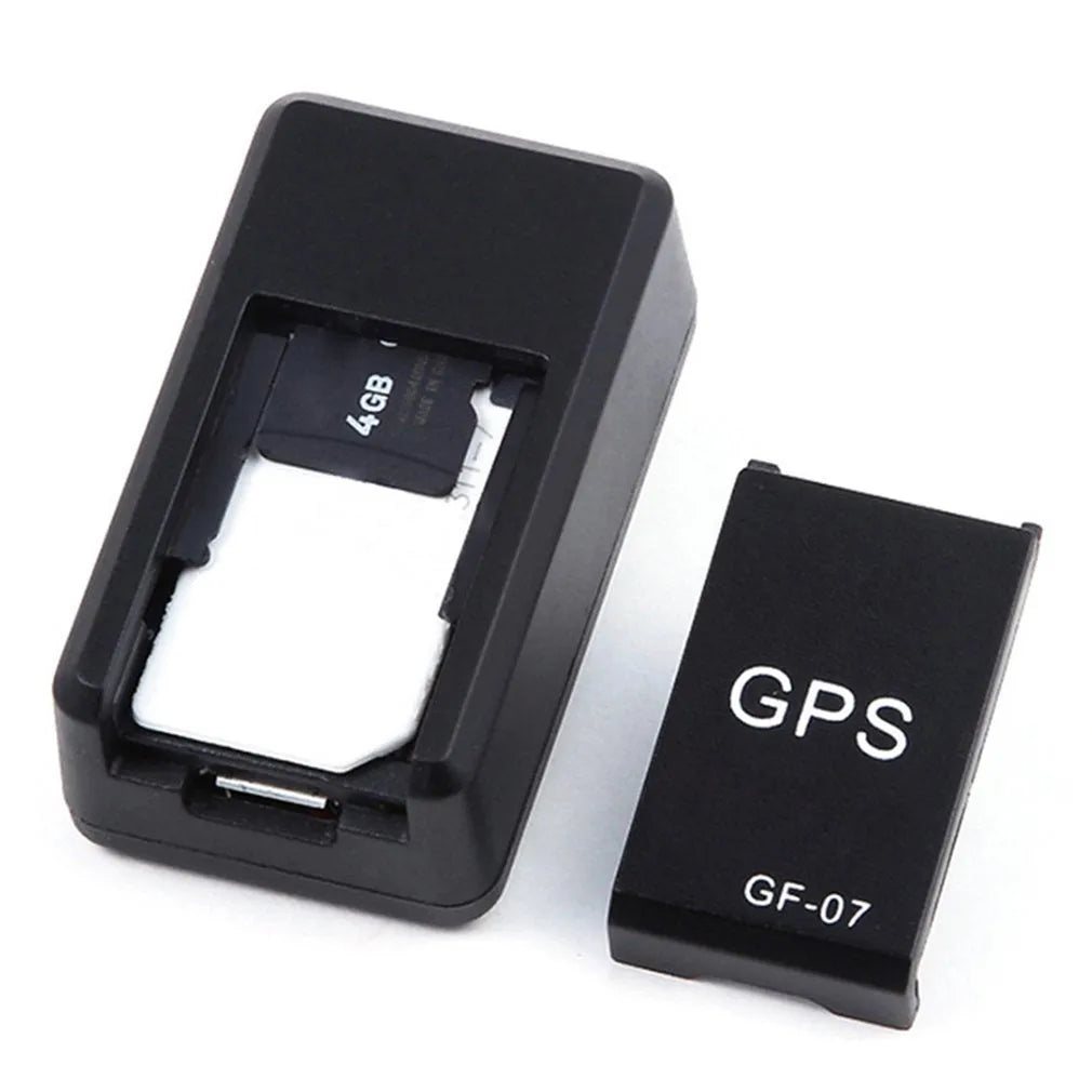 Small black magnetic GPS tracker device shown next to a USB charging cable.