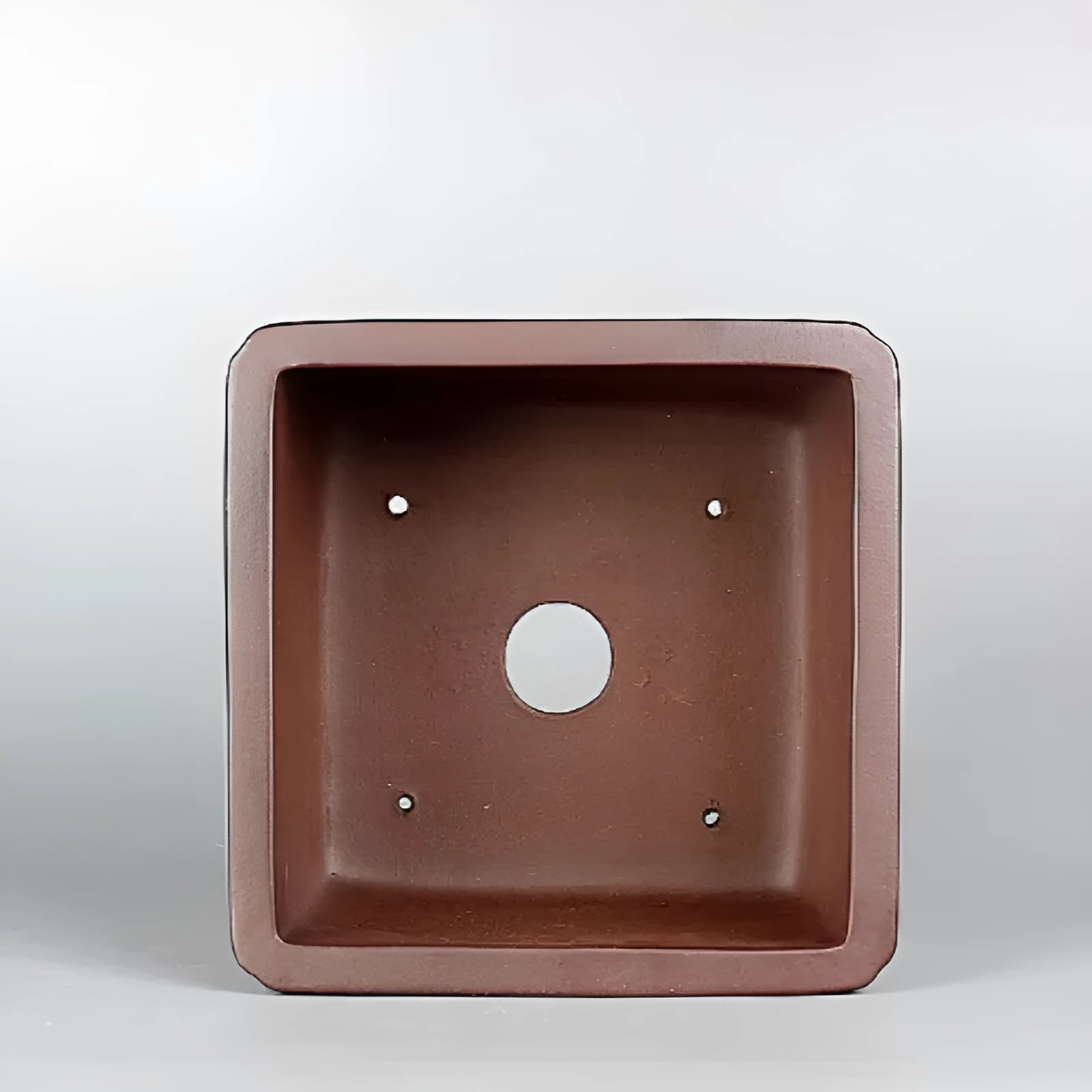 Brown handmade antique purple clay flower pot with classical design.
