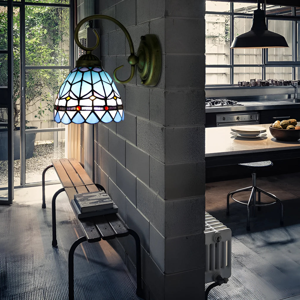 A coloured stained glass wall lamp mounted on a corridor wall, showing one of six available style designs.
