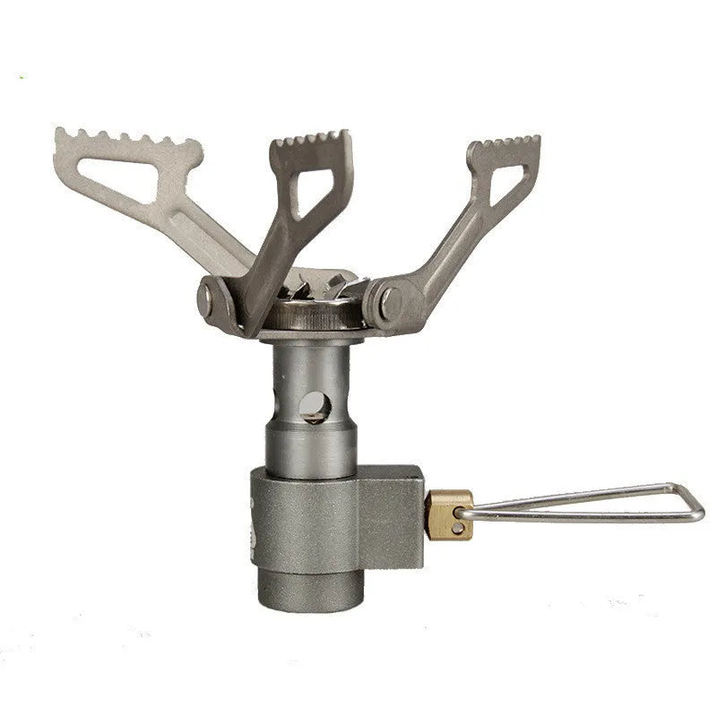 Silver portable propane camping stove with one-piece burner unit on a flat surface.
