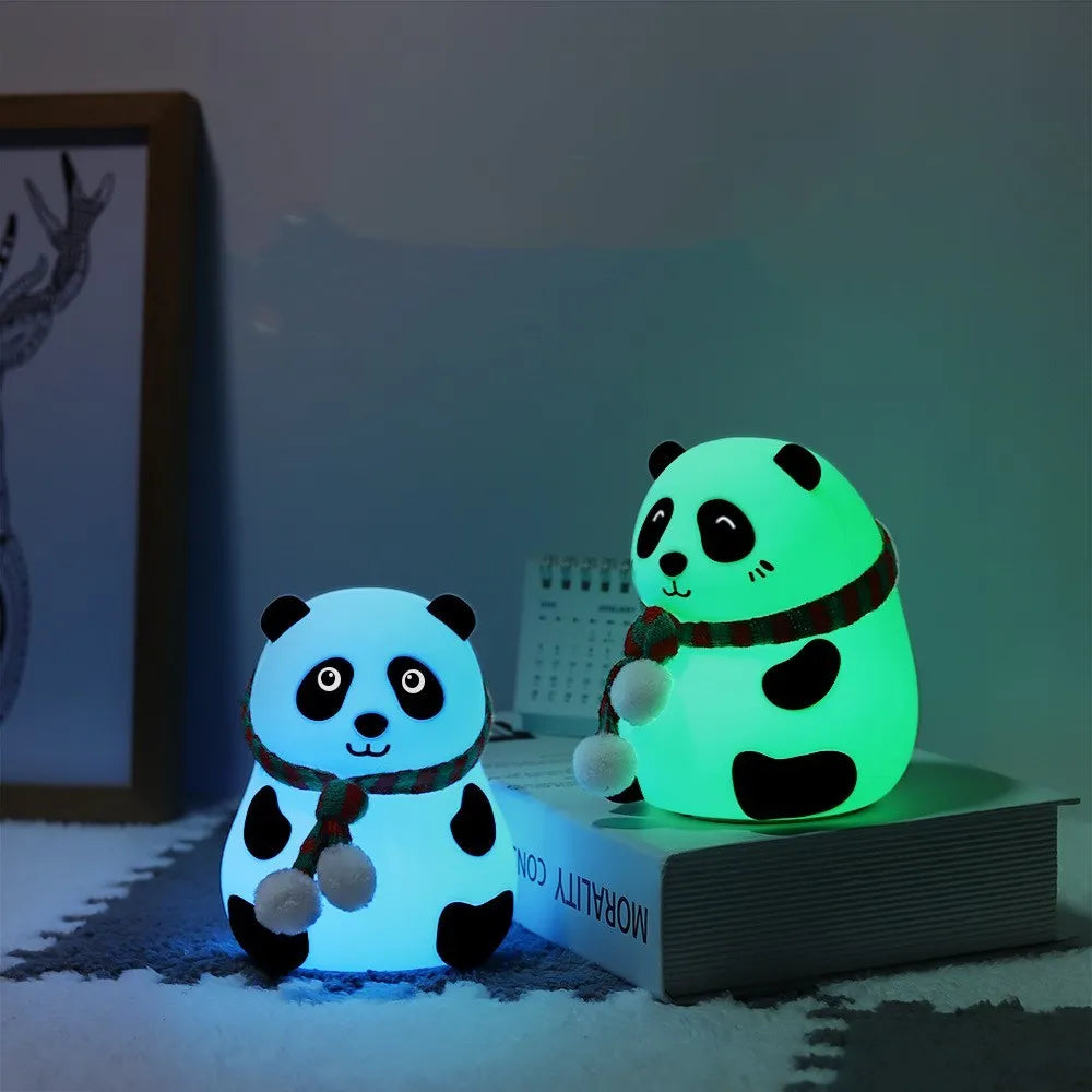 Panda-shaped soft silicone night light with USB rechargeable battery on a table.