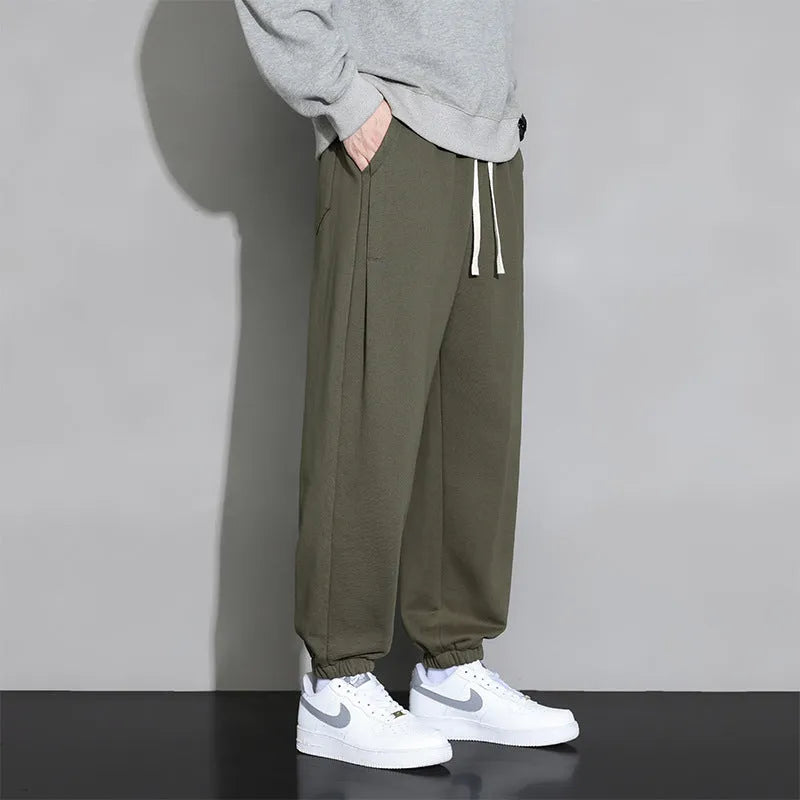Men's loose fit casual sports trousers in gray, black, or army green with drawstring waist