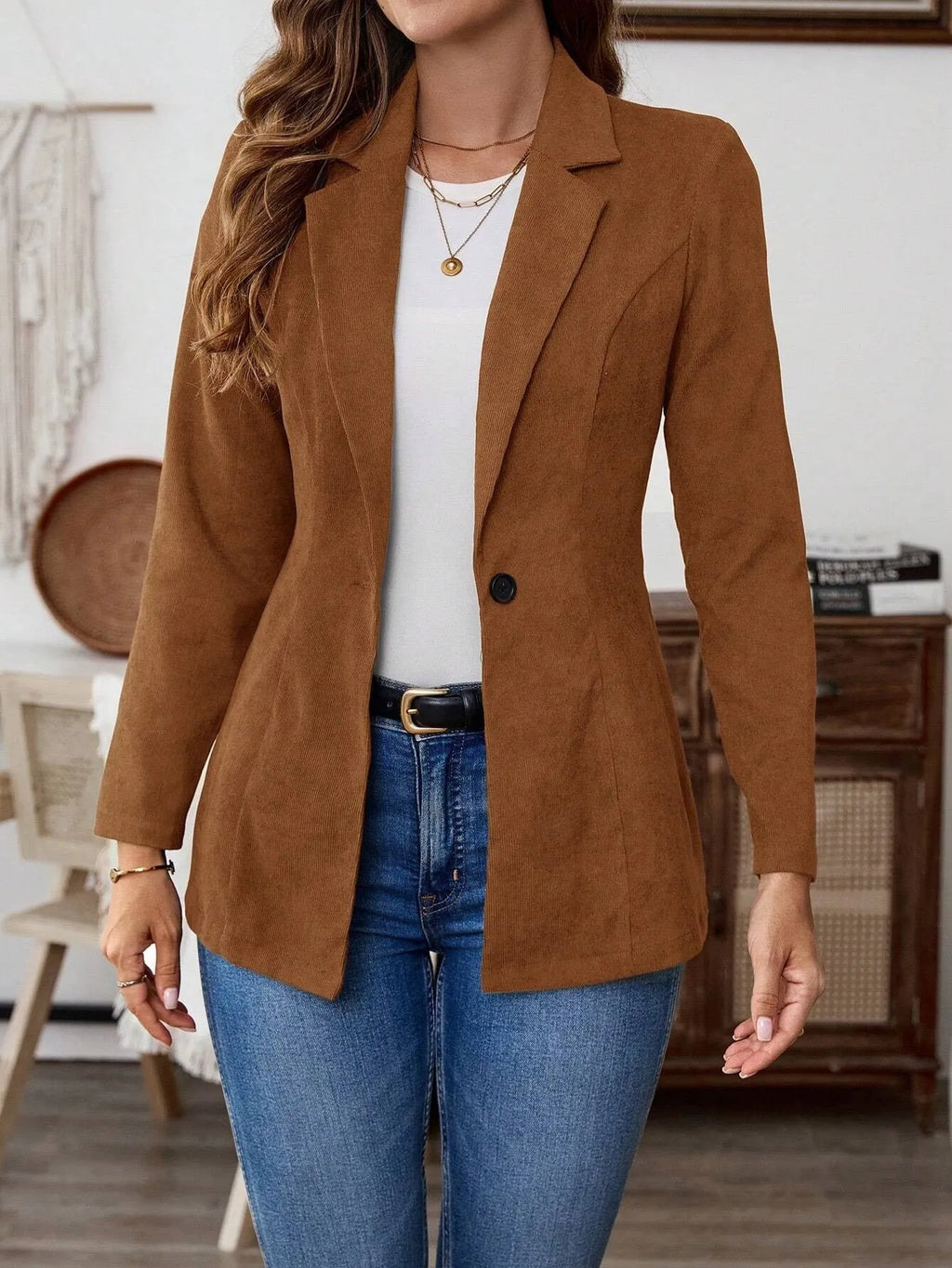 Brown men's single-breasted lapel suit coat on a hanger.