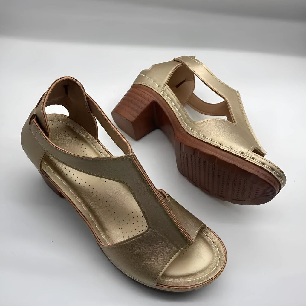 Womens beige Roman style wedge sandals with open peep toe and silver buckle strap on a low heel.