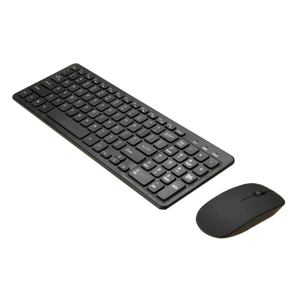 Black wireless keyboard and mouse set with USB receiver on a wooden desk.