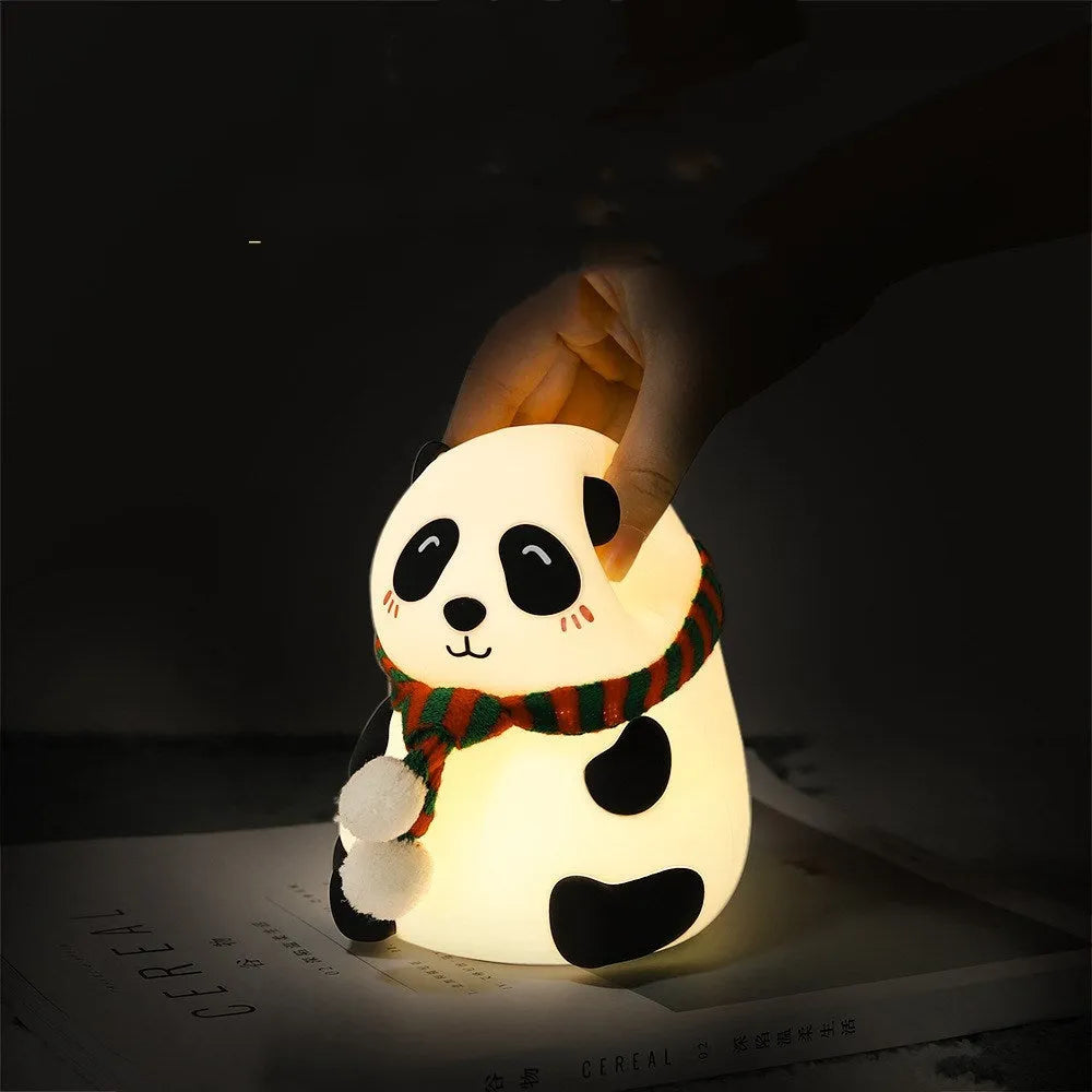 Panda-shaped soft silicone night light with USB rechargeable battery on a table.