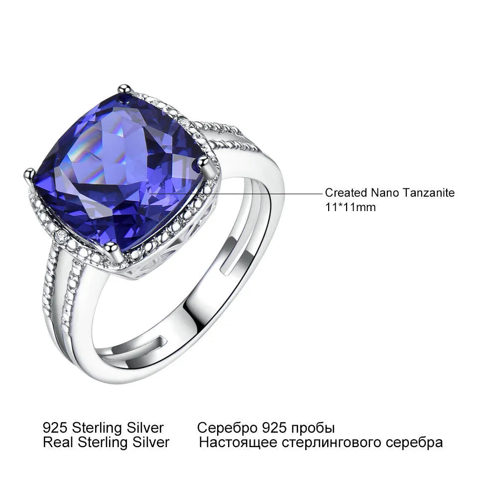 Blue Tanzanite stone set in a sterling silver women's ring on a plain background.
