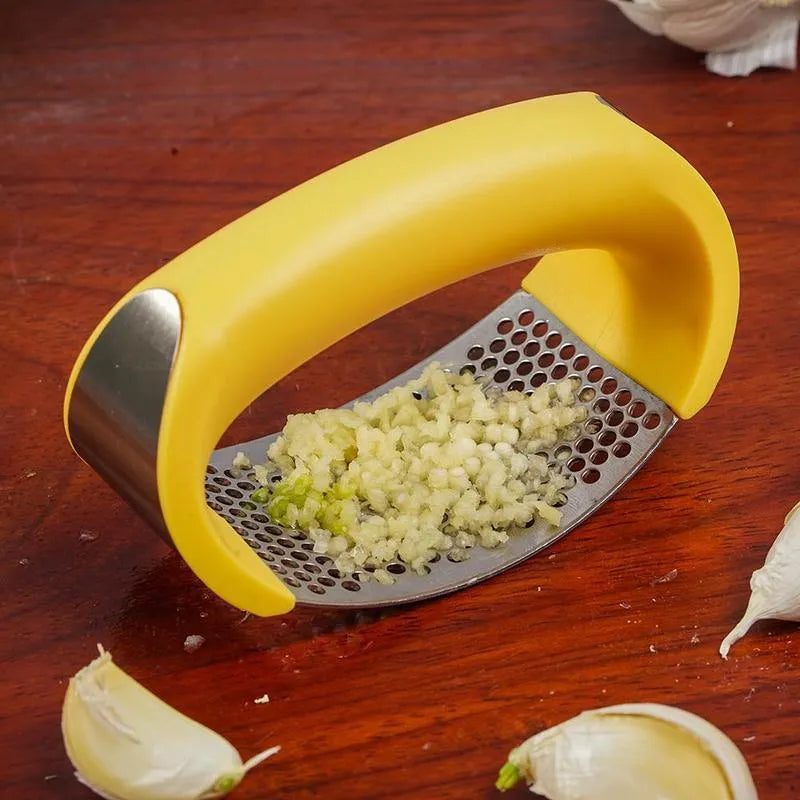 Stainless steel garlic press with non-slip handle in available colours crushing garlic